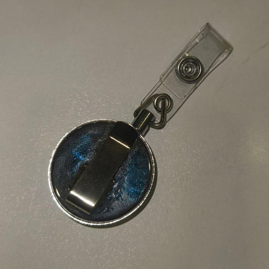 Metallic badge holder on a gray background